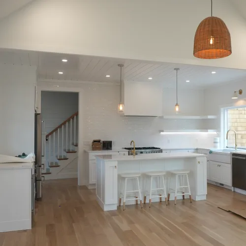Bright white kitchen with range and gold fixtures